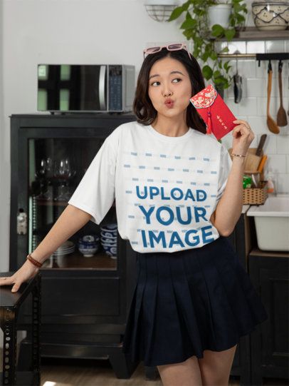 T-Shirt Mockup of a Woman Celebrating the Lunar New Year with a Red Envelope m52250