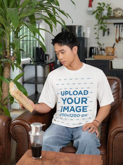 Lunar Year-Themed Crewneck Tee Mockup of a Man Reading at Home m52237