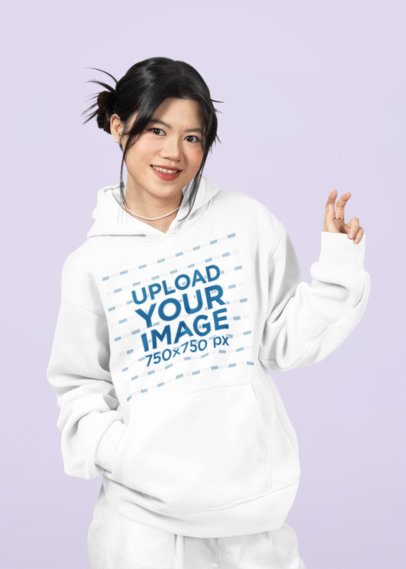 Mockup of a Joyful Teenage Girl Wearing a Pullover Hoodie in a Studio