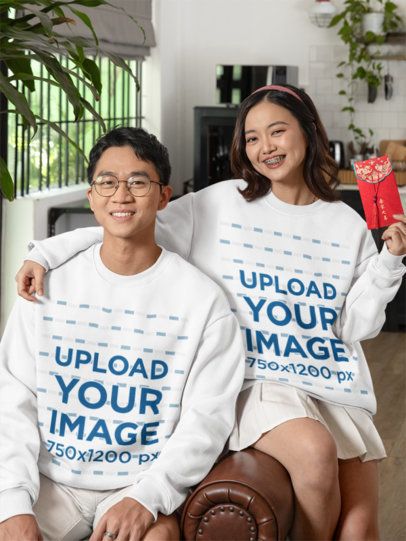 Lunar Year-Themed Mockup of a Man and a Woman Wearing Matching Sweatshirts at Home m52256
