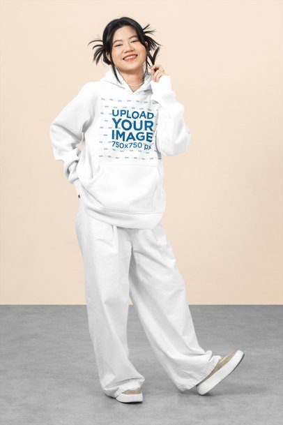 Mockup of a Happy Teenage Girl Wearing a Pullover Hoodie in a Studio