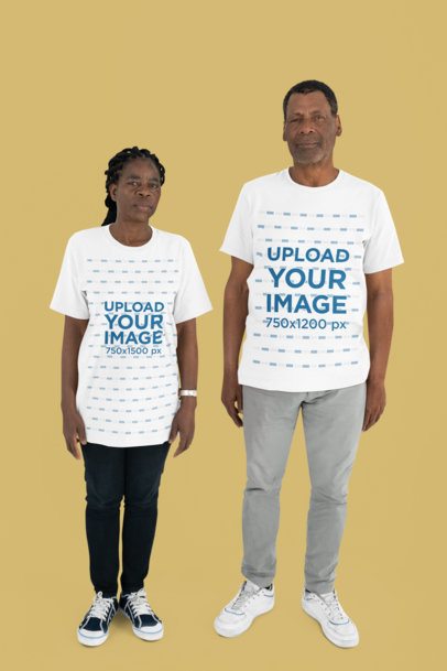 Mockup of Two Older Adults Wearing Oversized Bella Canvas T-Shirts in a Studio