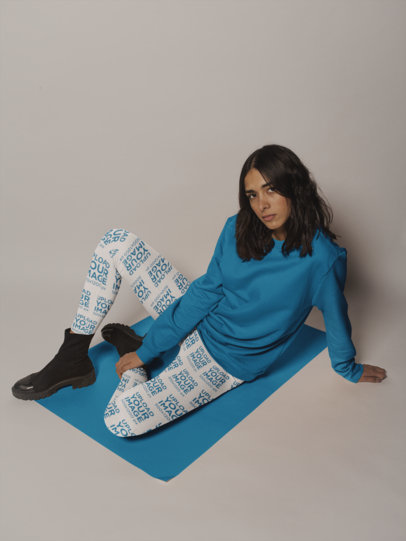 Mockup of a Woman Wearing Women's Leggings Posing on a Solid Color Pasteboard