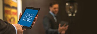 Mockup of a Corporate Man Using a Black iPad Mini