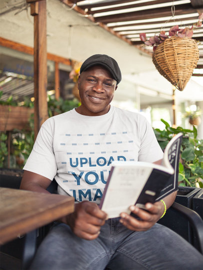 T-Shirt Mockup Featuring a Senior Man Reading a Book