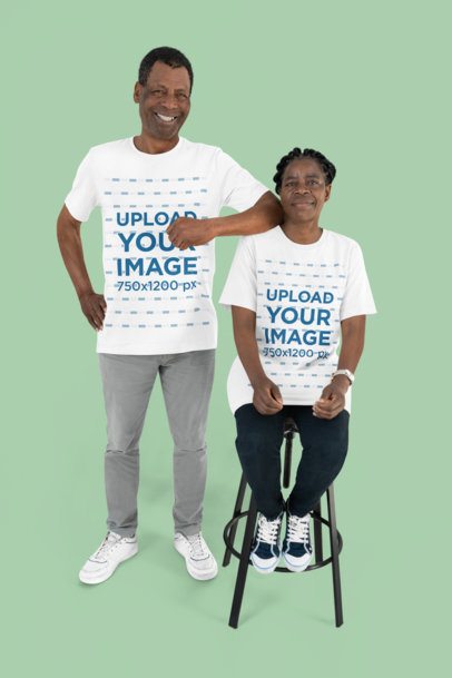 Mockup Featuring Two Happy Seniors Wearing Rounded-Neck T-Shirts in a Studio