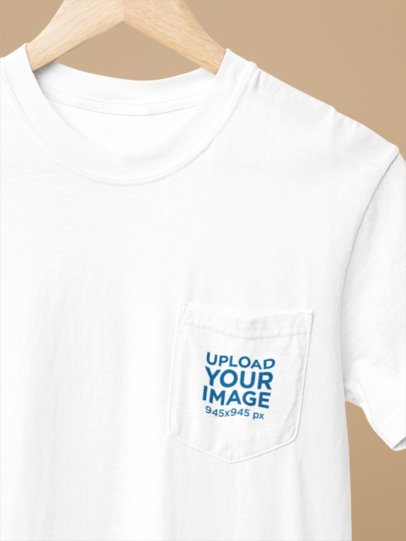 Mockup of a Comfort Colors Pocket Tee Placed on a Hanger Featuring a Customizable Backdrop m52786
