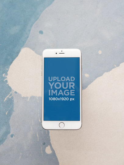 Mockup of a Gold iPhone 8 Plus Floating Against a Paint Stain on a Wall