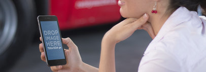 Young Lady Using an iPhone 6 Featuring a Red Vehicle -