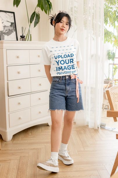Round-Neck T-Shirt Mockup of a Teenage Girl Posing in a Nice Room