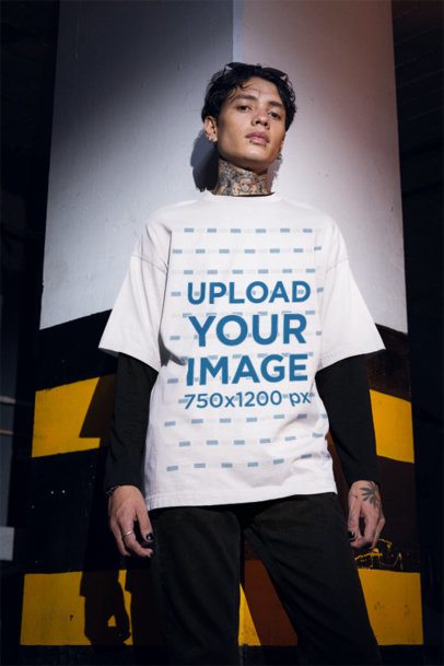 Mockup of a Tattooed Man Wearing an Oversized T-Shirt in a Dark Parking Lot m50779