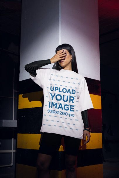 Mockup Featuring a Woman Wearing an Oversized Tee in a Dark Parking Lot m50784