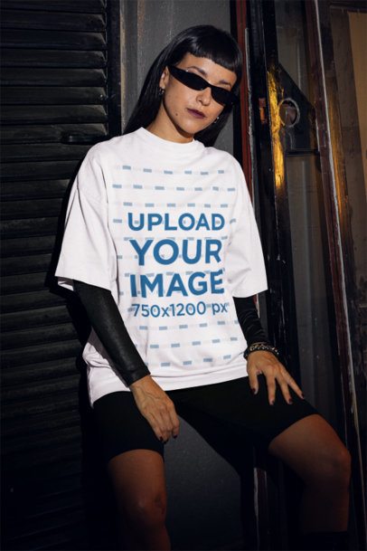 Grunge-Style Mockup of a Woman Wearing an Oversized Tee in a Dark Urban Setting m50786