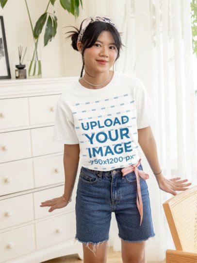 Oversized T-Shirt Mockup Featuring a Smiling Teenage Girl Standing in a Nice Room