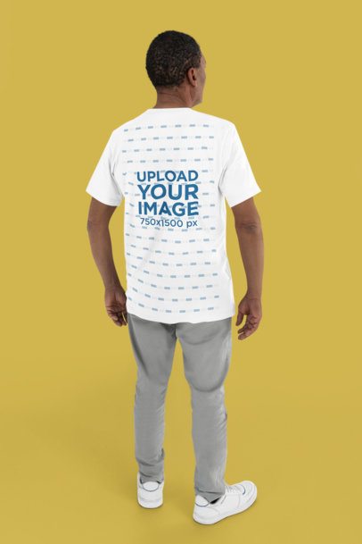 Back-View Mockup of a Man Wearing a Bella Canvas Round-Neck Tee in a Studio