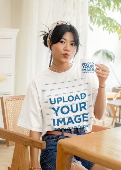 Round-Neck T-Shirt Mockup of a Teenage Girl Holding a Coffee Mug at Home