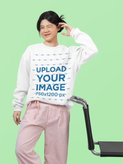 Crewneck Sweatshirt Mockup Featuring a Teenage Girl Winking Her Eye