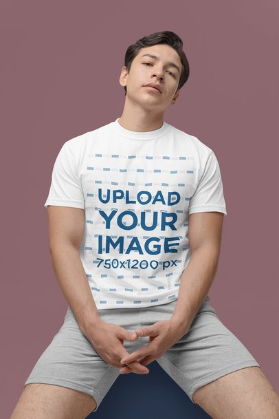 Comfort Colors Tee Mockup Featuring a Serious Man Sitting in a Studio m53019