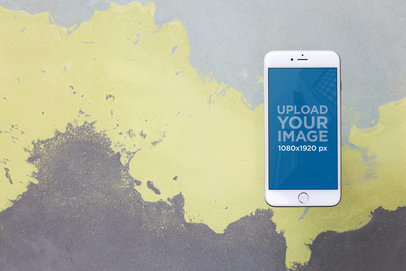 Silver iPhone 8 Plus Mockup Against a Painted Wall