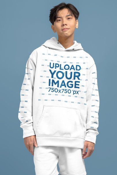Pullover Hoodie Mockup of a Teen Boy Posing in a Studio With a Customizable Backdrop m51435