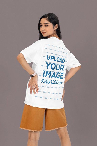 Back-View Oversized Tee Mockup of a Woman Posing in a Studio Against a Colorful Background