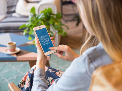 Overshoulder Mockup of a Woman Using a Rose Gold iPhone