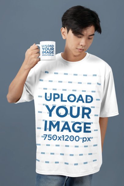 Coffee Mug Mockup Featuring a Teenage Boy Posing in a Studio With an Oversized T-Shirt