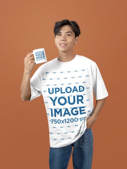 Oversized T-Shirt Mockup Featuring a Smiling Teenage Boy With a Sublimated Coffee Mug