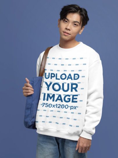 Crewneck Sweatshirt Mockup of Teenage Boy Standing Against a Customizable Backdrop
