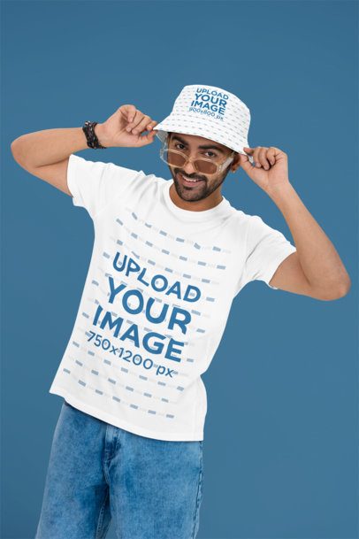 Round-Neck T-Shirt Mockup Featuring a Smiling Man Wearing a Bucket Hat and Sunglasses