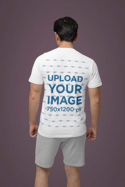 Back-View Comfort Colors Tee Mockup of a Man Standing Against a Colorful Wall m53024
