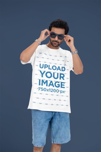 Oversized T-Shirt Mockup Featuring a Man Putting on His Sunglasses in a Studio