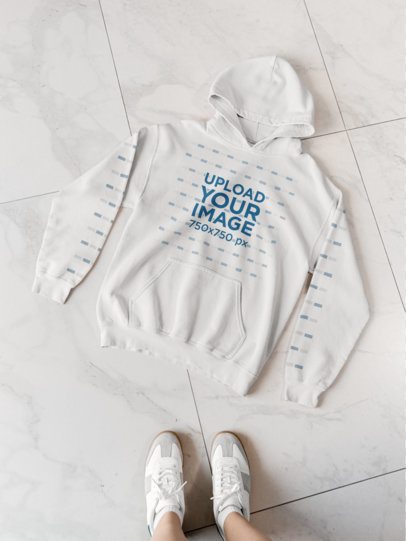 POV-Themed Mockup Featuring a Gildan Hoodie With Customizable Sleeves Lying on the Floor