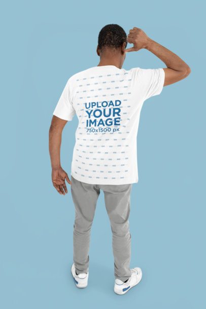 Back-View Mockup Featuring a Senior Man Pointing at His Bella Canvas T-Shirt in a Studio