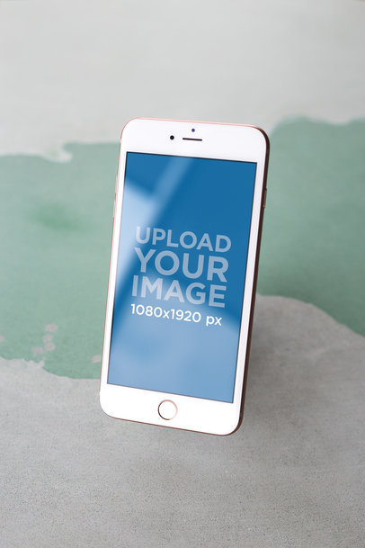 Mockup of a Rose Gold iPhone 7 Plus Floating Over a White and Green Surface