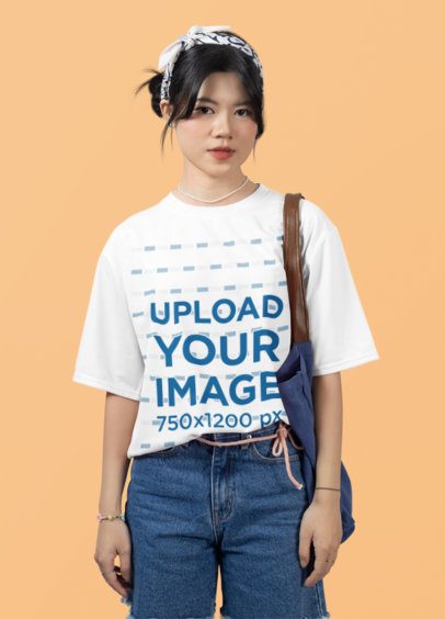 Oversized Round-Neck Tee Mockup Featuring a Woman Posing Against a Customizable Backdrop