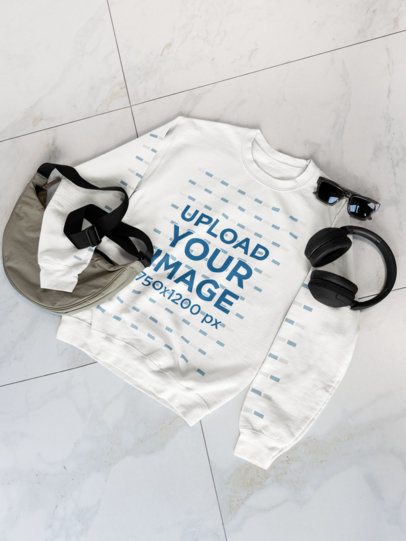 Mockup of a Gildan Sweatshirt Lying on a Marble Floor With Sunglasses and Headphones