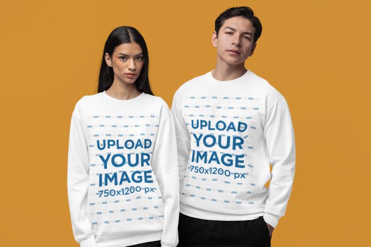 Mockup of a Man and a Woman Standing in a Studio Wearing Comfort Colors Sweatshirts