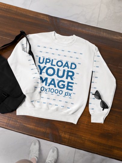 Gildan Mockup Featuring a Sweatshirt on a Wooden Surface With a Bag and a Pair of Sunglasses m52002