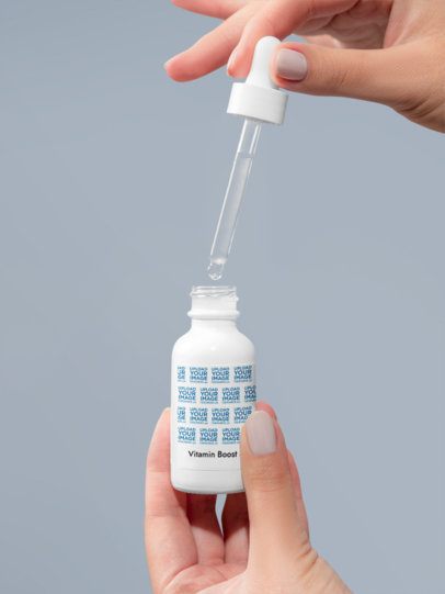 Vitamin Boost Serum Mockup Featuring a Woman's Hands With an Open Dropper m53608