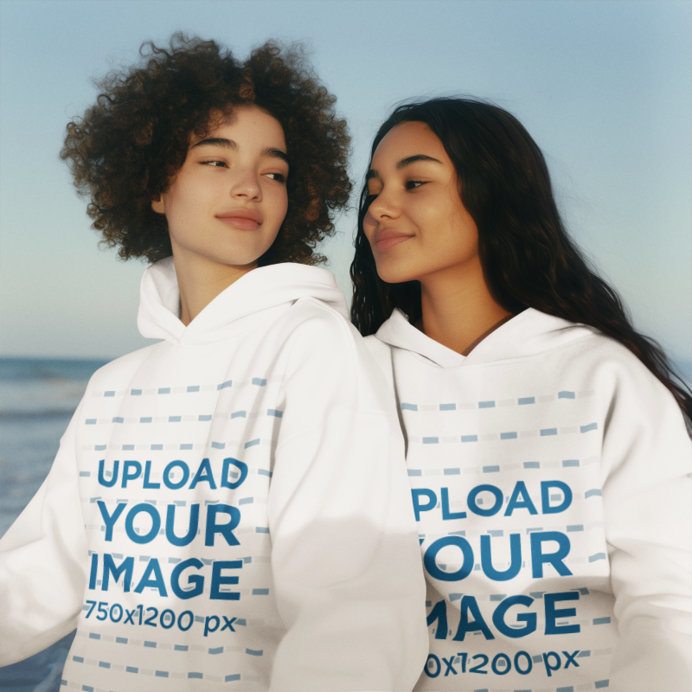 Hoodie Mockup of a Smiling AI-Generated Women Couple Posing in a Beach