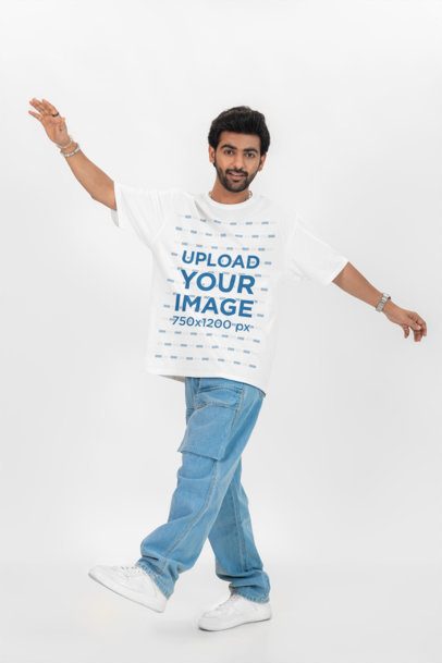Oversized T-Shirt Mockup of a Smiling Bearded Man Posing in a Studio