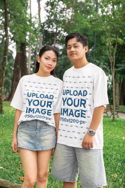 Oversized T-Shirt Mockup Featuring a Smiling Couple Posing in a Park for Valentine's Day