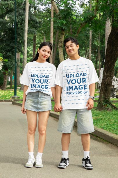 Valentine's Day Mockup of a Couple Wearing T-Shirts While Walking and Holding Hands in the Park
