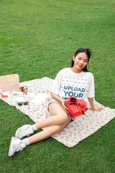 Oversized T-Shirt Mockup of a Smiling Woman in a Valentine's Day Picnic