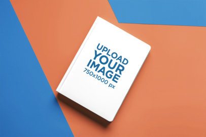 Print Mockup Featuring an AI-Created Hardcover Journal Lying on a Colorful Background