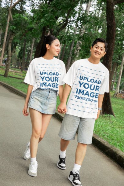 Oversized T-Shirt Mockup of a Romantic Couple Walking in the Park for Valentine's Day