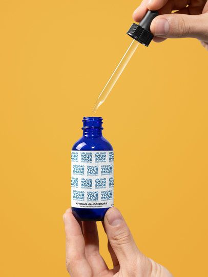 African Mango Drops Supplement Mockup Featuring a Man Opening a Dropper m53464
