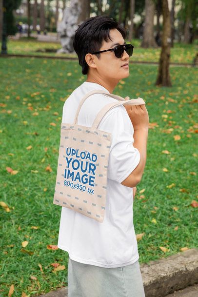 Mockup of a Serious Man With a Sublimated Tote Bag on His Back Posing in the Park m53746