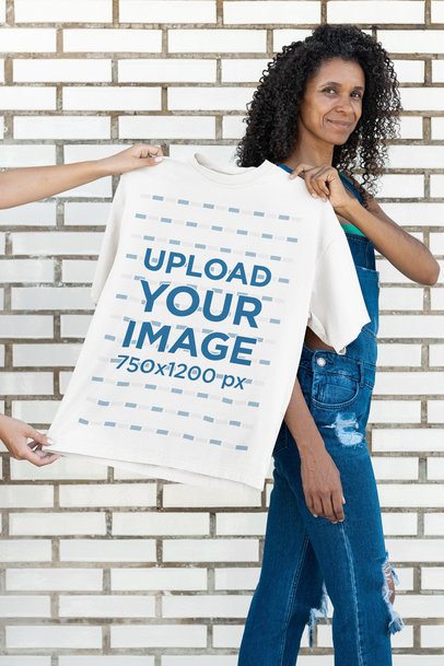 Apparel Mockup Featuring a Smiling Woman Holding a Bella Canvas Tee While Walking m51769